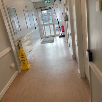 Internal corridor from the entrance, it is wide and flat. There are buttons on the walls for opening doors.
