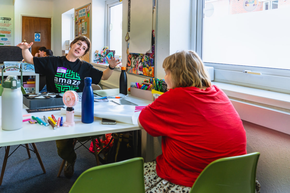 Brighton lead, Sally B, talks to a young person.