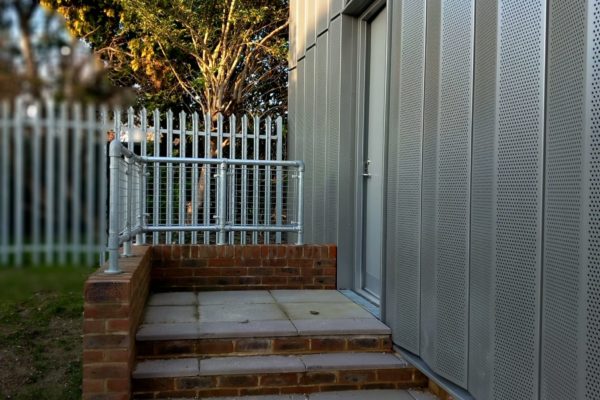 The side door is up two steps. There are sturdy railings.