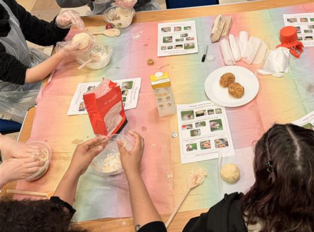Young people mixing flour and other ingredients to make their dough