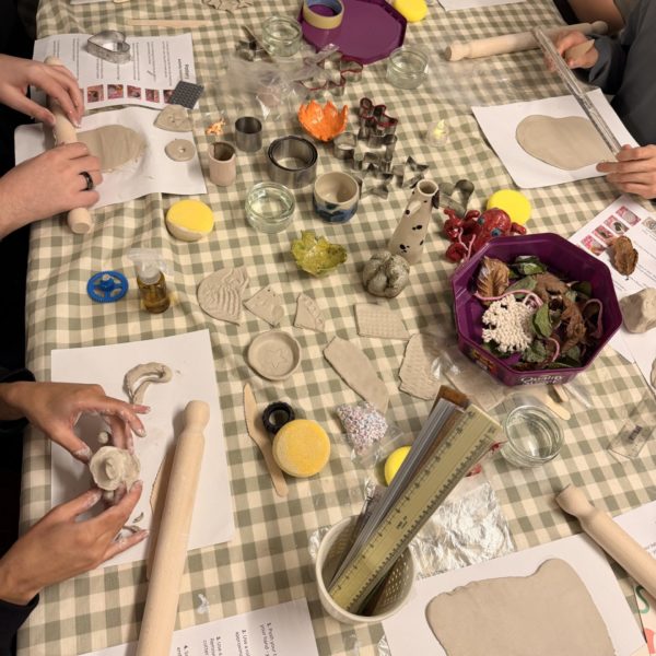 Young people making pots from clay