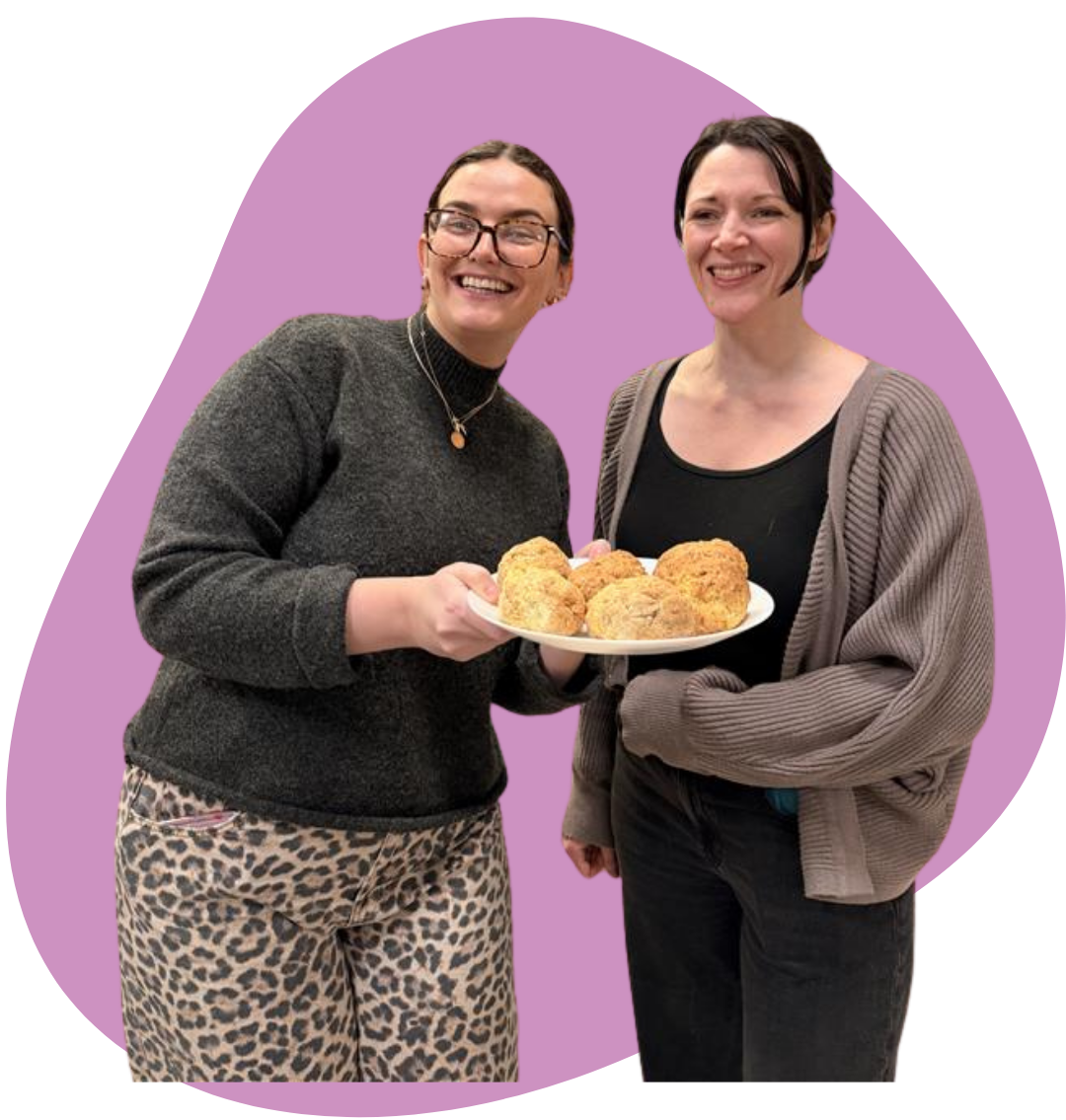 Nancy and Louise holding a plate of soda bread rolls from the baking session.