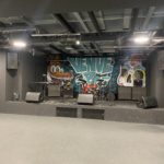 Stage set up for a band, with graffiti art on the wall behind reading "Venue B".