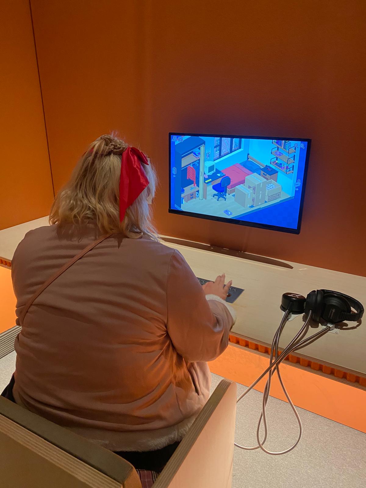 Young person playing a computer game at the exhibition