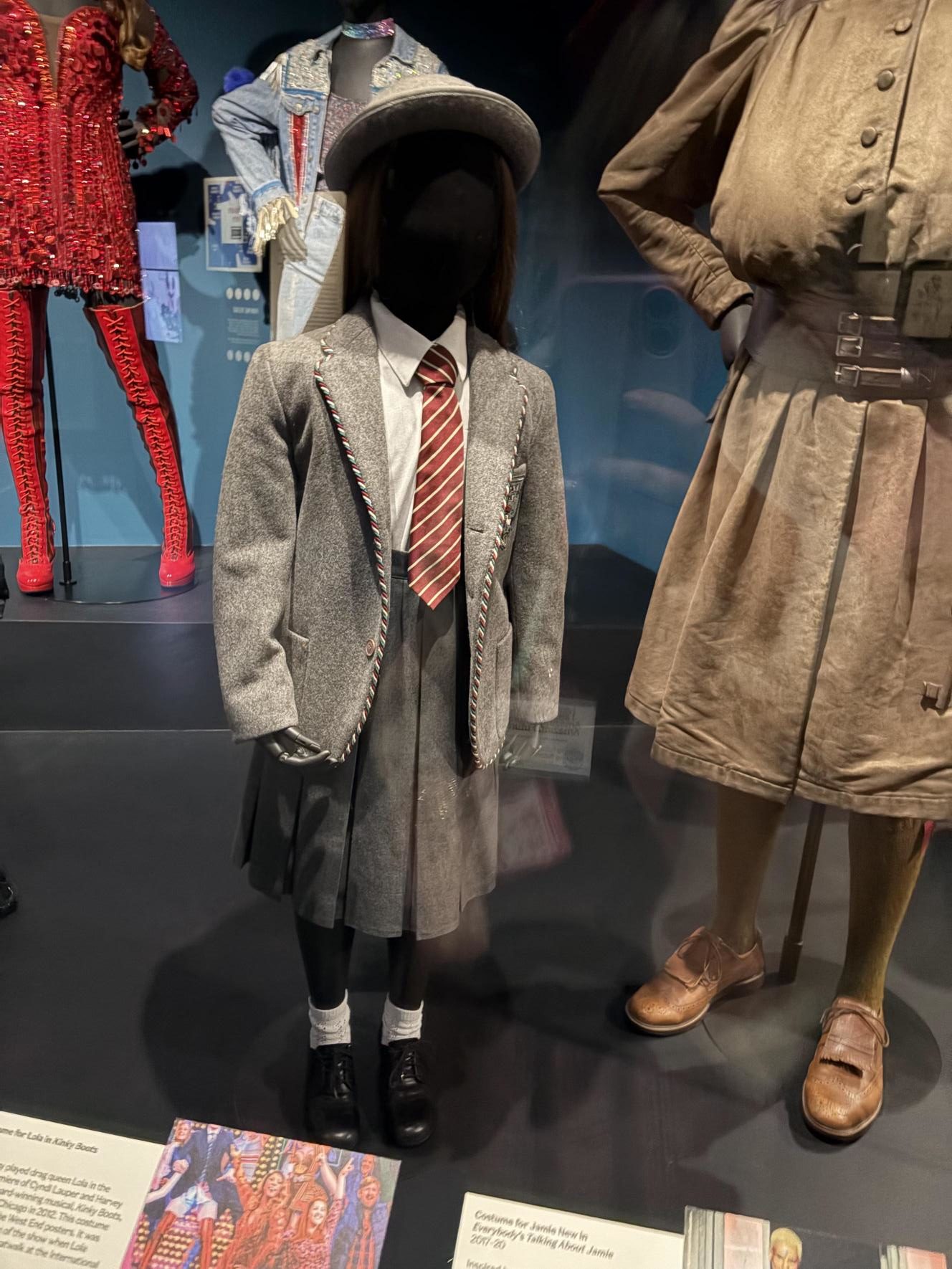 Grey schoolgirl uniform on display from the musical Matilda.