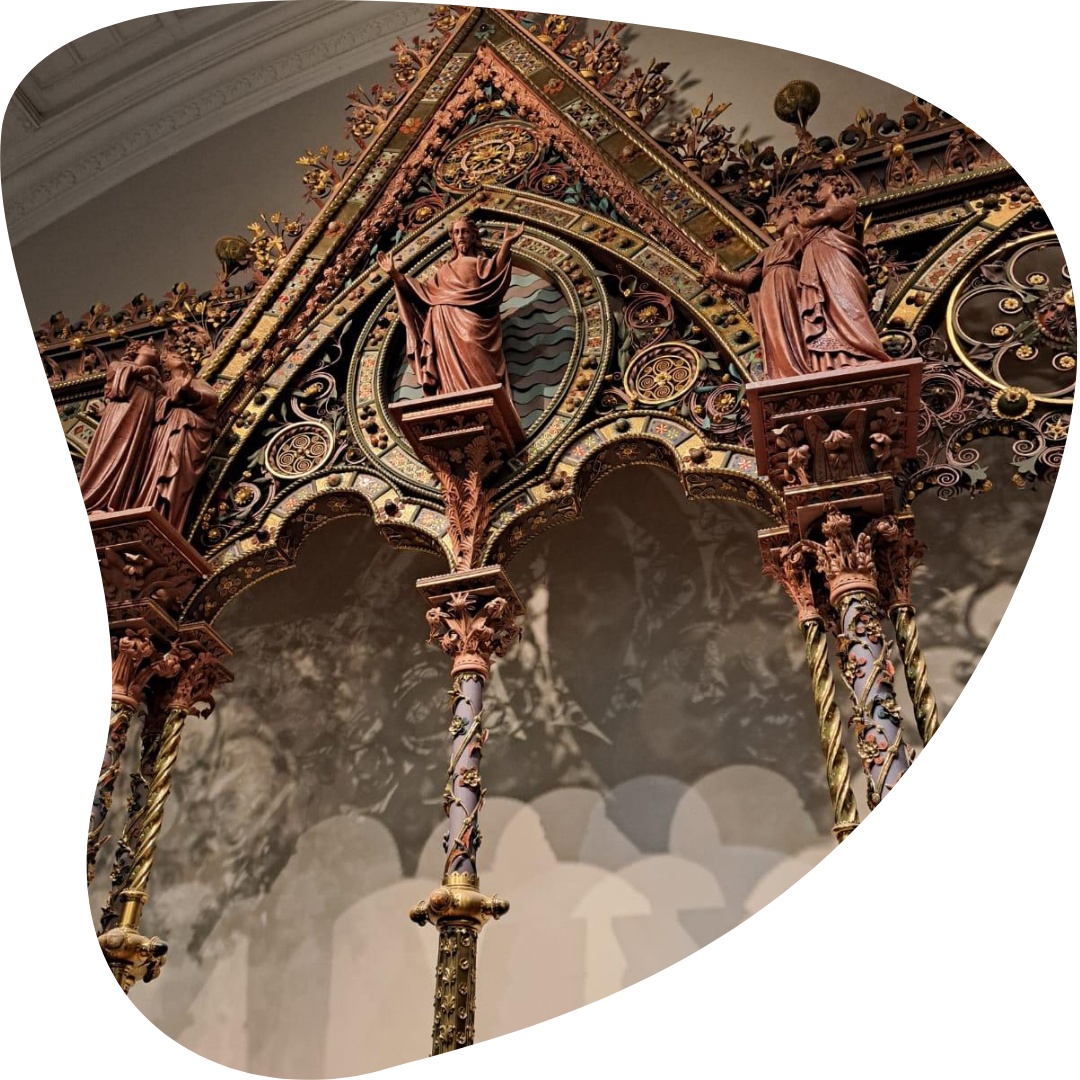 Close-up on an intricate altar, featuring statues and columns.