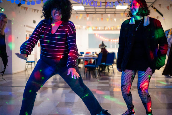 Young people dancing with disco lights