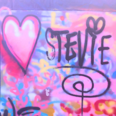13 Brightly coloured, heavily layered spray art, featuring a large heart and the word "Stevie"