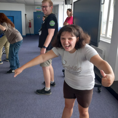 14 A young person with their arms out, laughing, in the middle of a game.