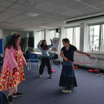19 Two young people hula-hooping, while another watches.
