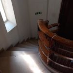 Large spiral staircase with bannister.