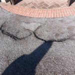 Ground outside one of the entrances. There are two cracks creating ridges of an inch or more.