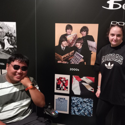 short breaks 2026 blog post images (1) Two young people next to a photographic display at Brighton Museum.